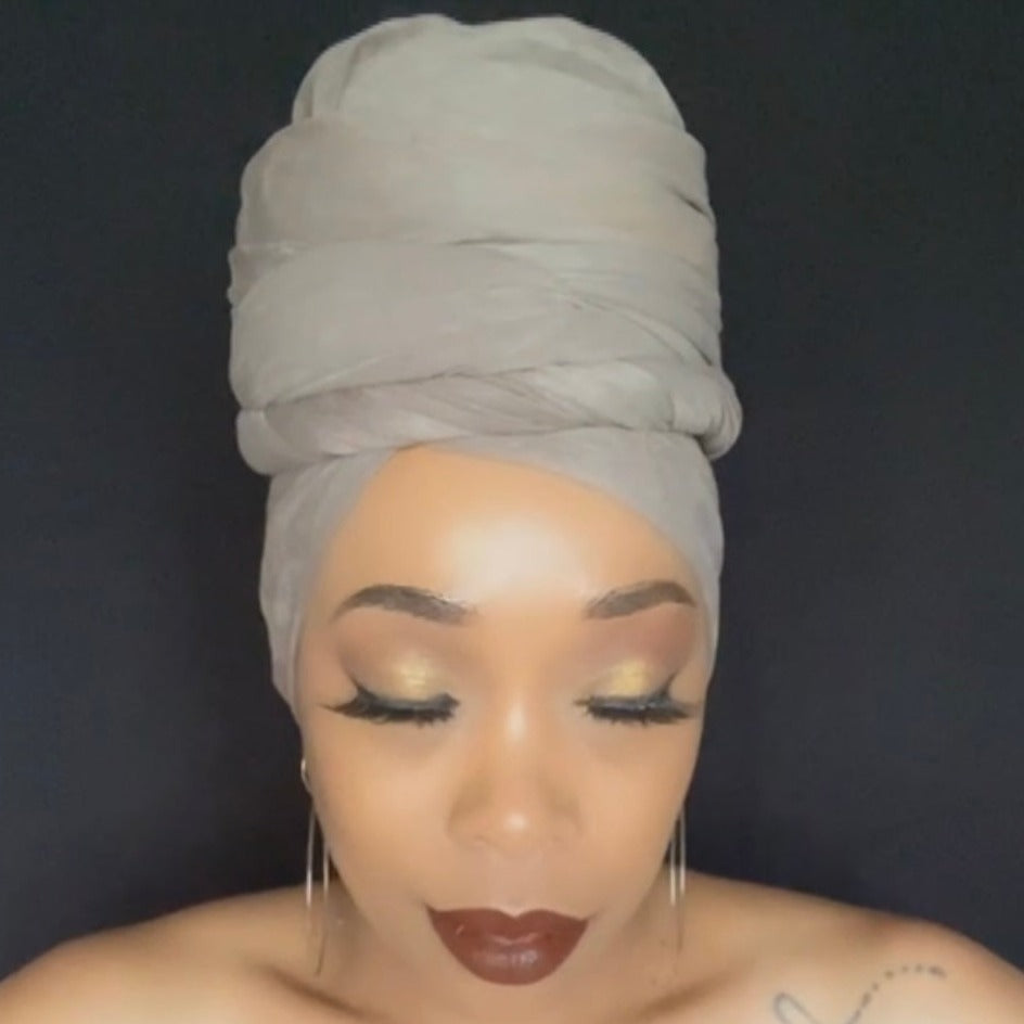 black model wearing soft, textured, stretchy, grayish- brown faux suede head wrap
