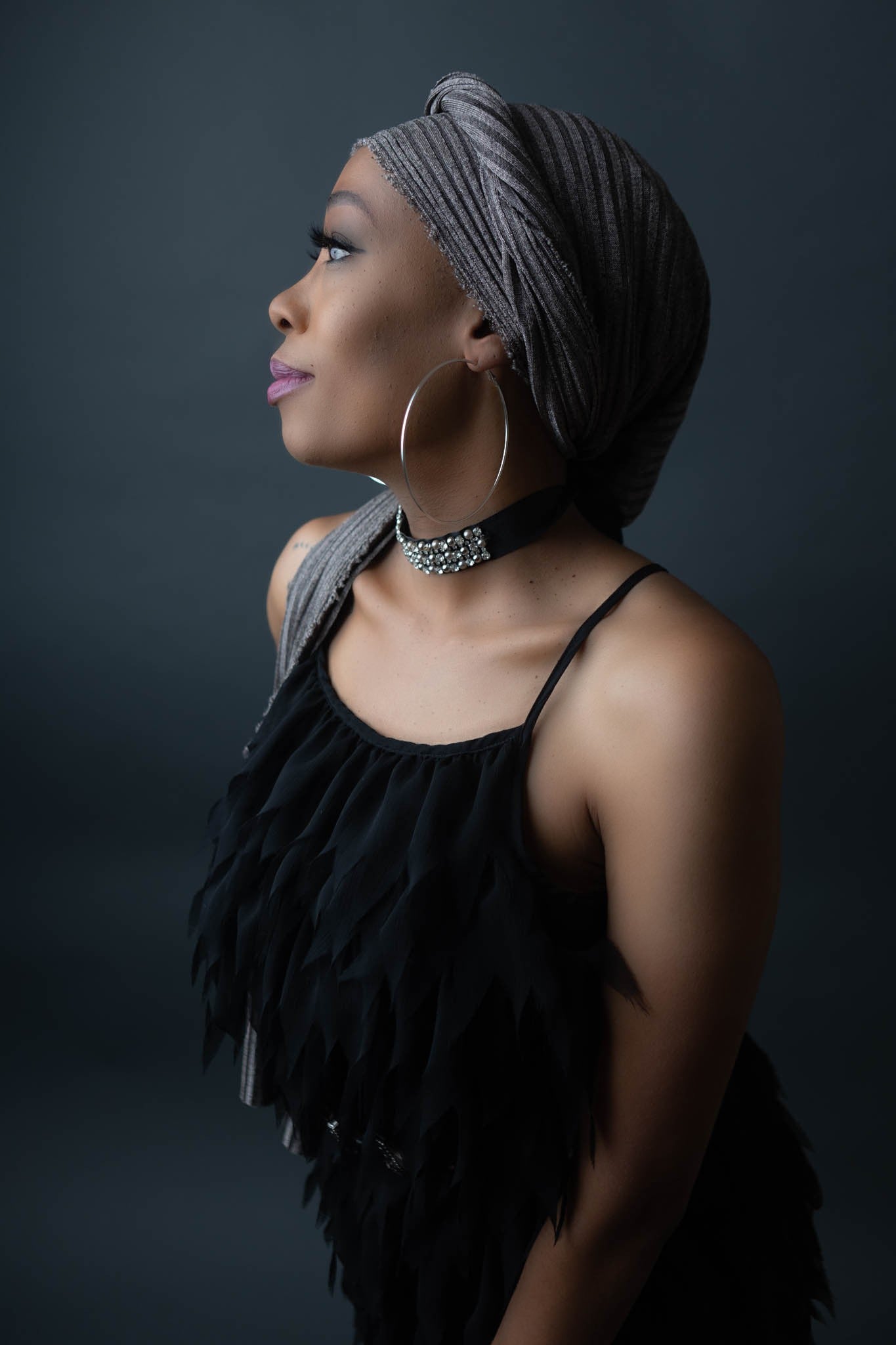 black model wearing stretch shimmery silver head wrap