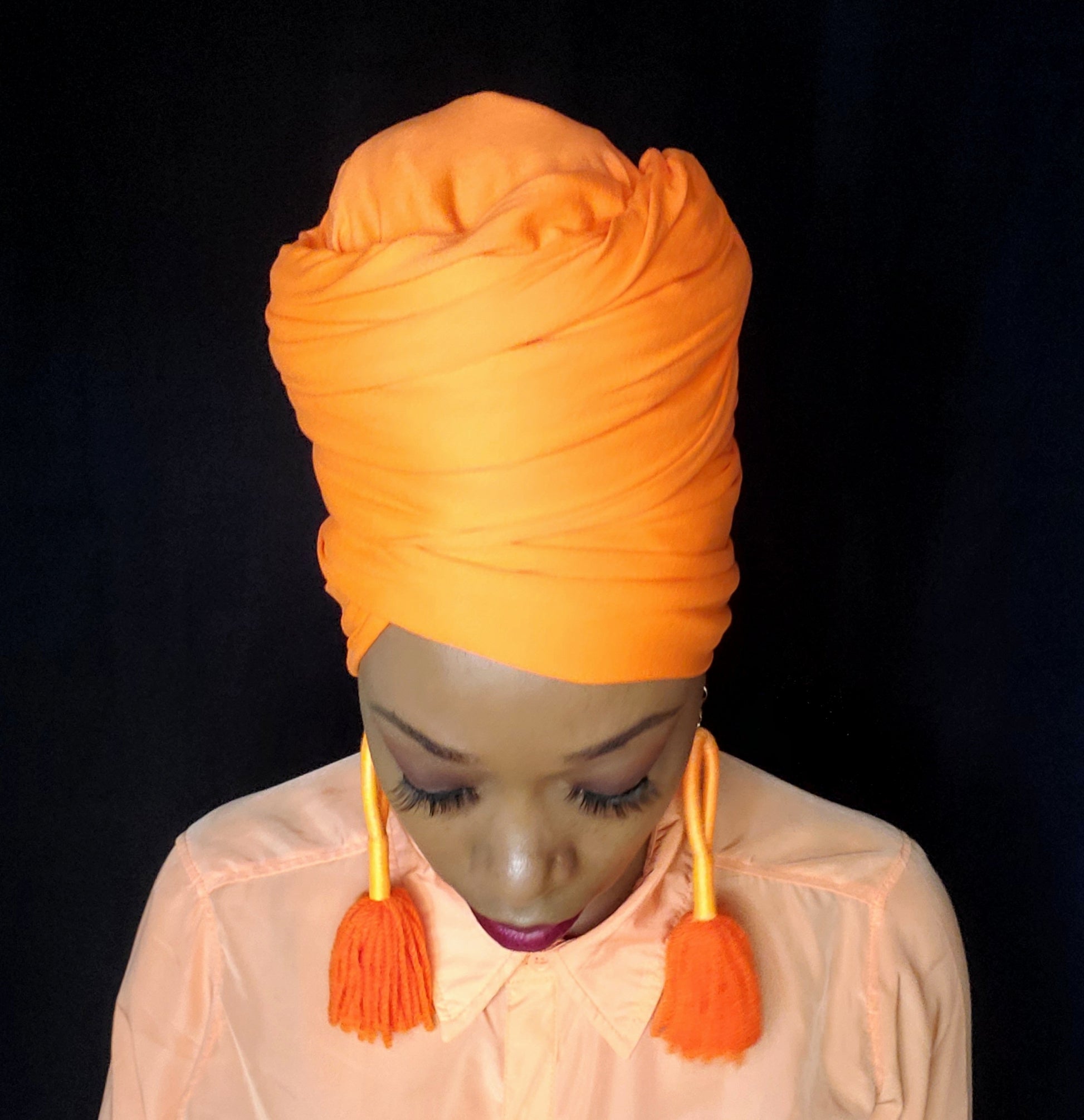 black woman wear stretch hot orange headwrp