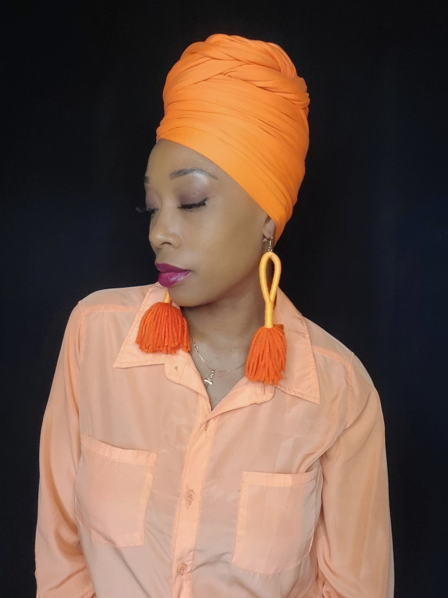 black woman wearing stretchy hot orange headwrap
